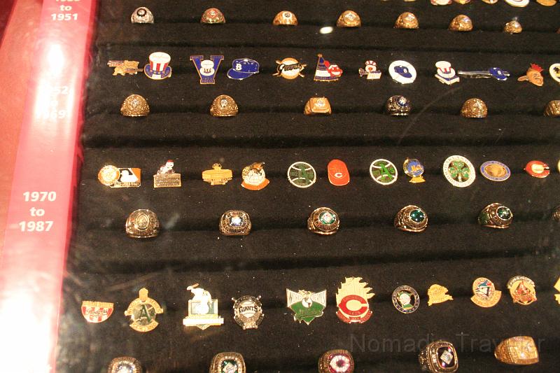 IMG_0160.JPG - Baseball rings and pins. Impossible to get a good picture with the glare of the lights.